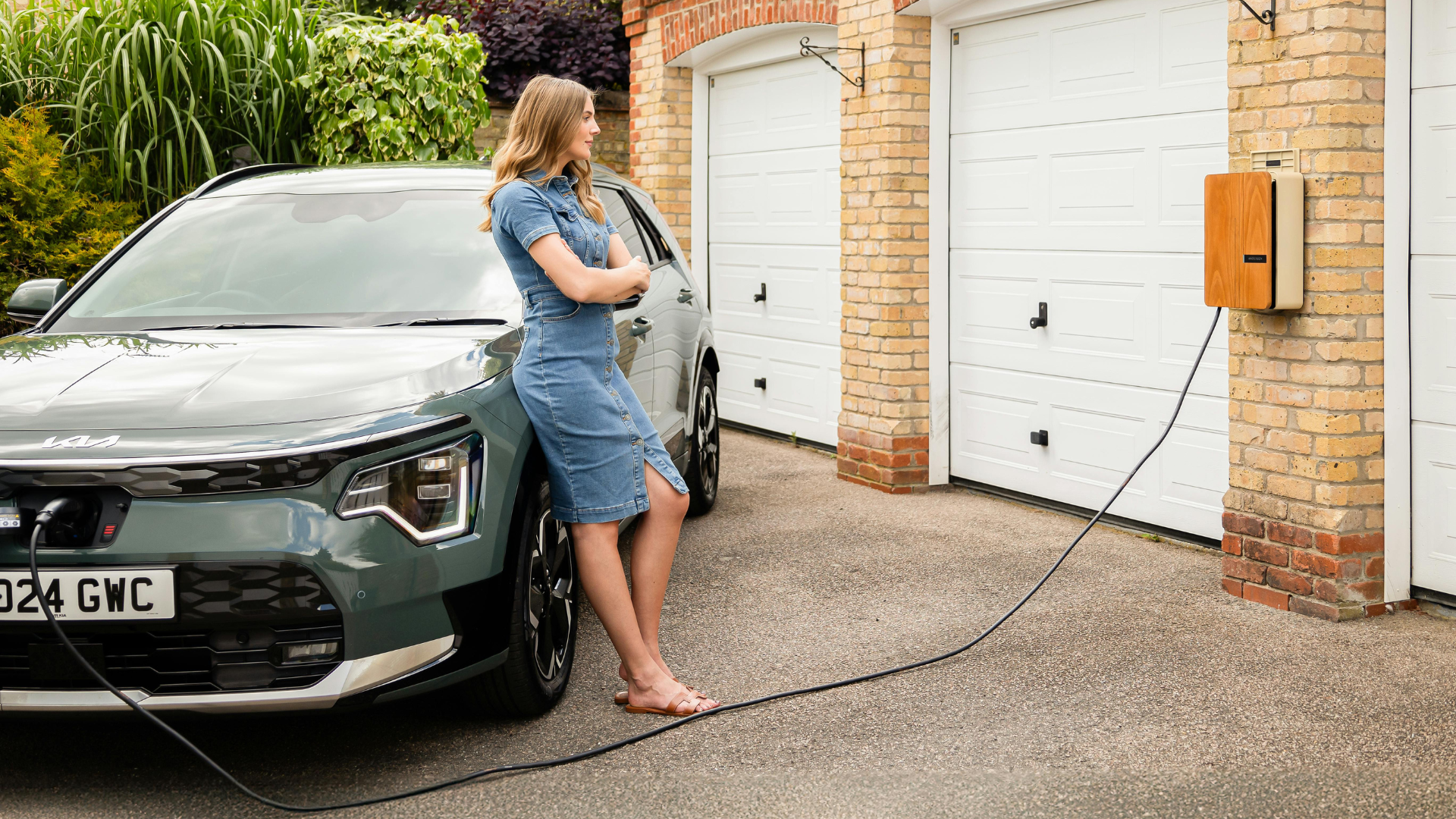 Woman standing next to electric car